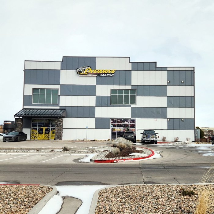 Completed Overdrive Raceway building exterior with gray and white checkered metal panel facade